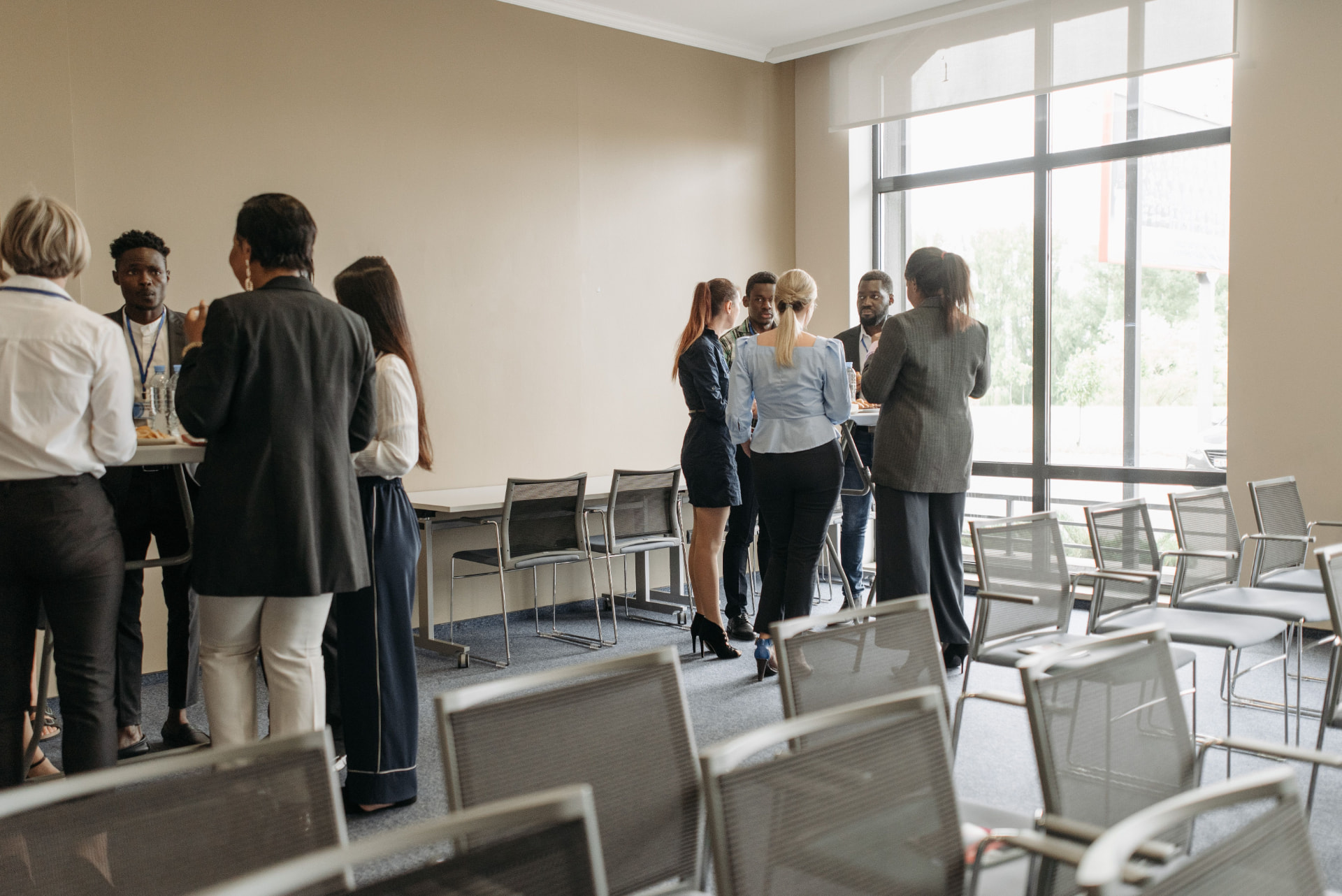 Christian business owners networking in small groups at a Wichita professional meeting