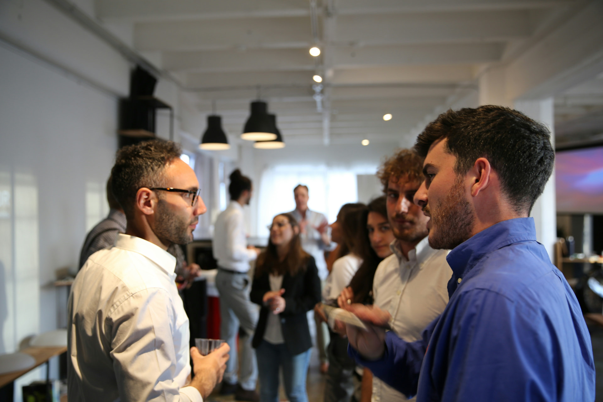 Two Christian business owners shaking hands at a downtown Wichita networking gathering